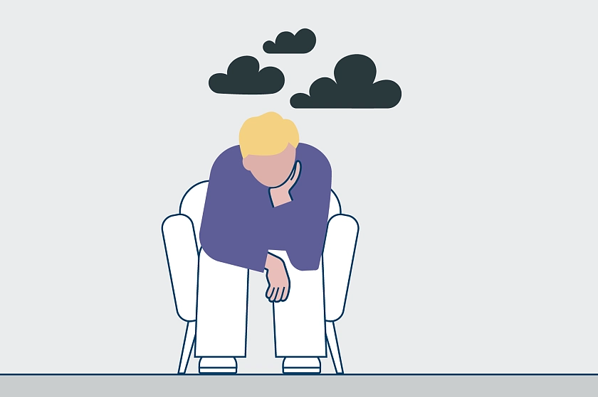 sitzender Mensch mit dunklen Wolken über dem Kopf 