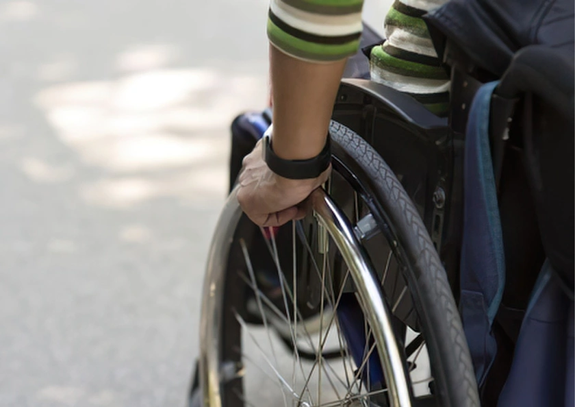 Photo crop of a person in a wheelchair.