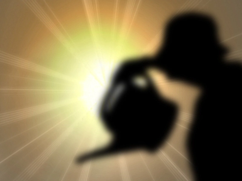 Person with watering can in front of sun.